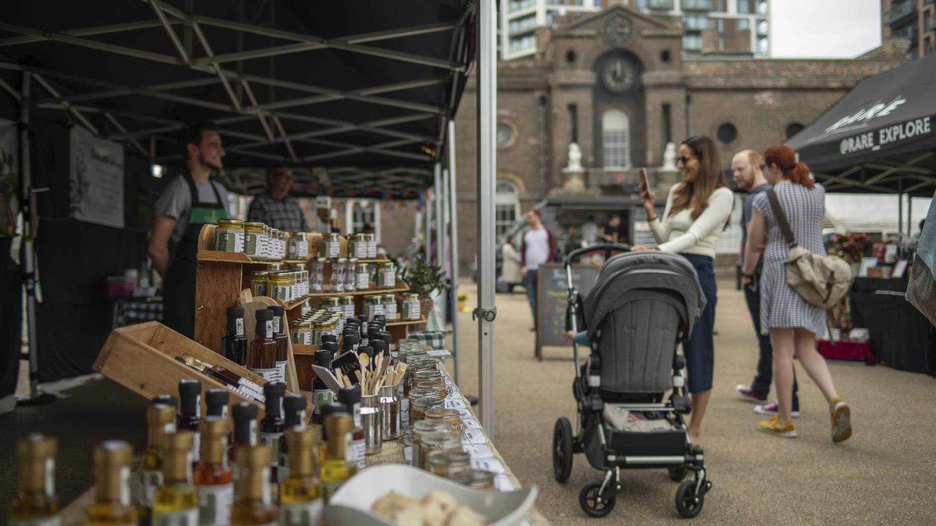 People stop to look at the stalls at Royal Arsenal Farmers' Market in Woolwich, Greenwich.