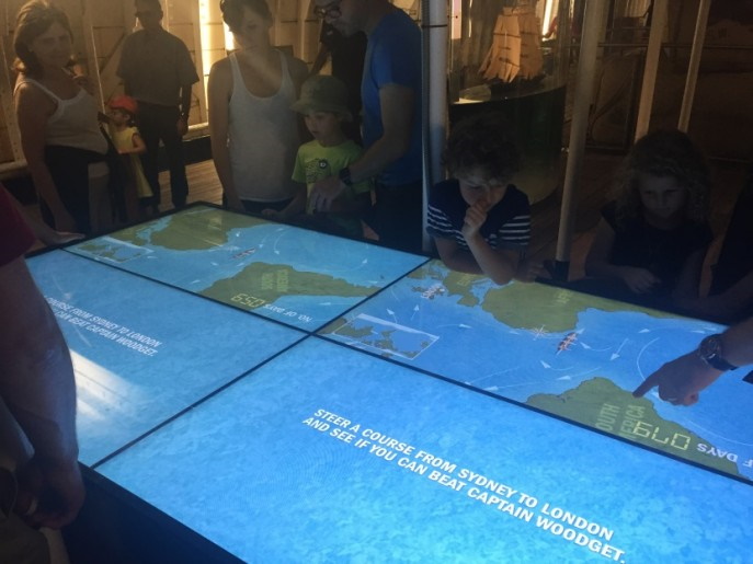 visitors with interactive screens at the cutty sark, greenwich