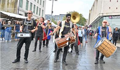 Brass band marching through Woolwich town centre