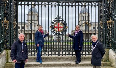 Image shows the Water Gate at The Old Royal Naval College and the two domes of Old Royal Naval College through the gates in the background.