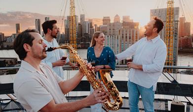Exclusive Friday night climbs with a twist: refreshing beverage, sky-high sunsets, and live saxophonist performance playing classic summertime tunes