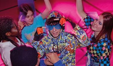 A group of “neeks” gather to hold a midnight rave