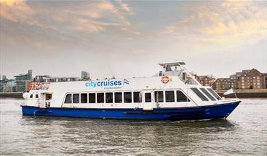 Blue and white City Cruises boat on the River Thames