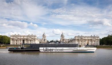 Uber Boat by Thames Clippers sailing on the River Thames overlooking the Old Royal Naval College