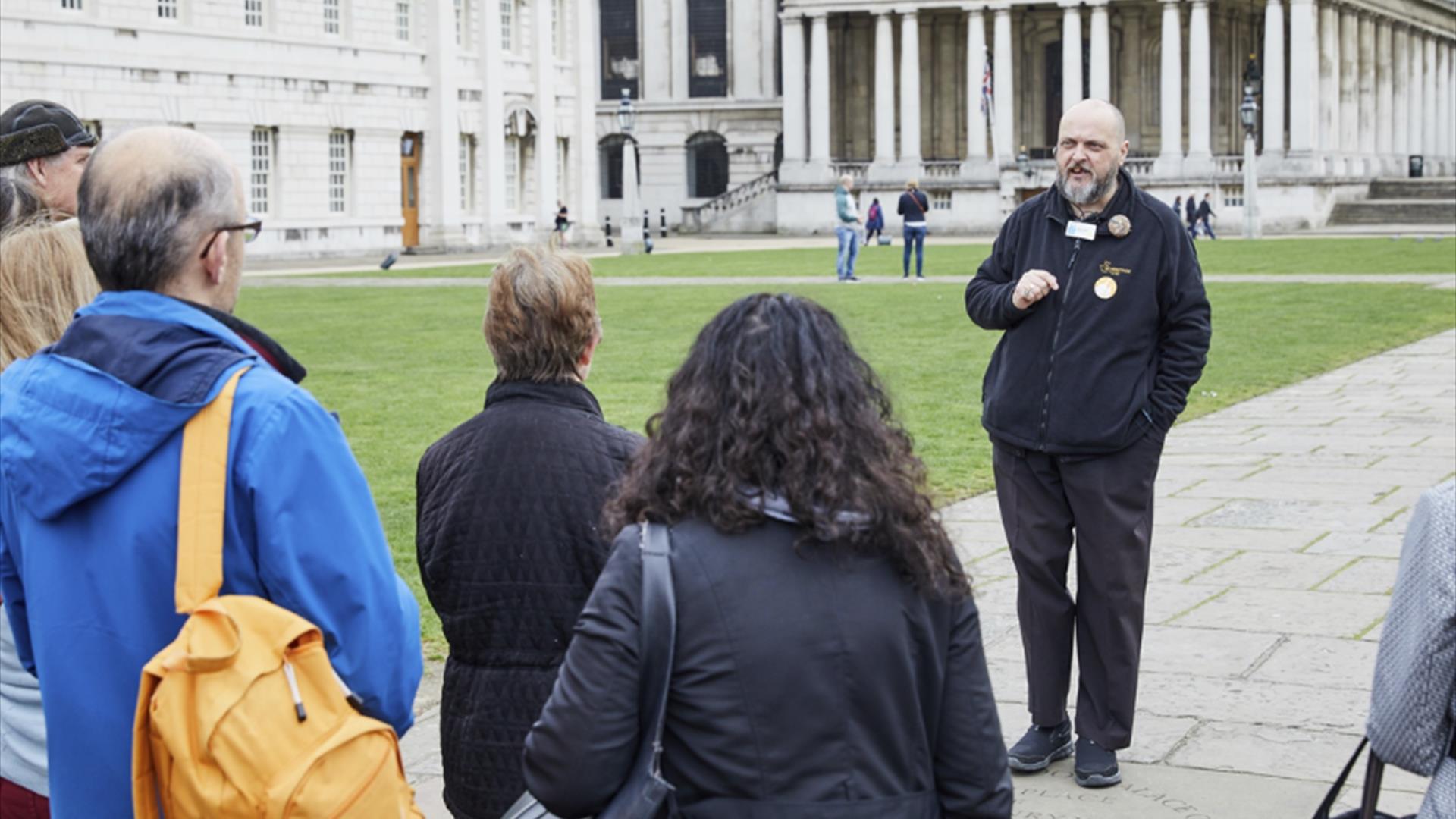 A group attend a sightseeing tour of the Old Royal Naval College in Greenwich.