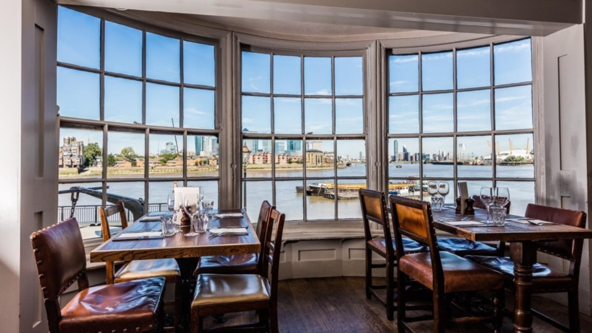 The view from a table at the Cutty Sark pub in Greenwich which overlooks the river Thames to Canary Wharf and Greenwich Peninsula.