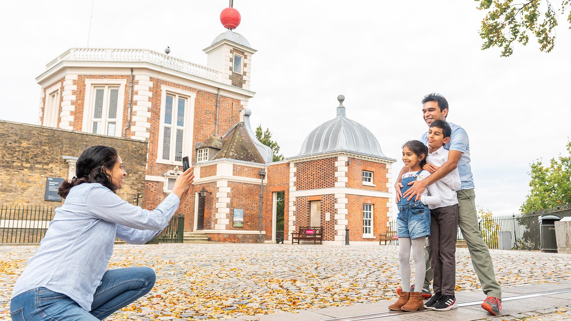 A family on the Meridian Line at the Royal Observatory in Greenwich.