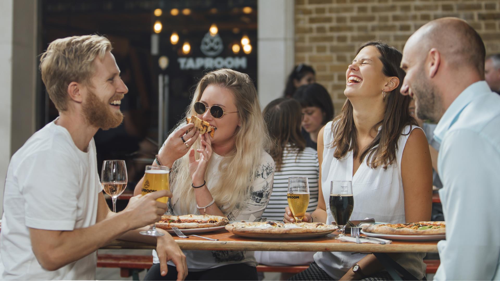 A group sit outside the Taproom in Woolwich for food and drink.