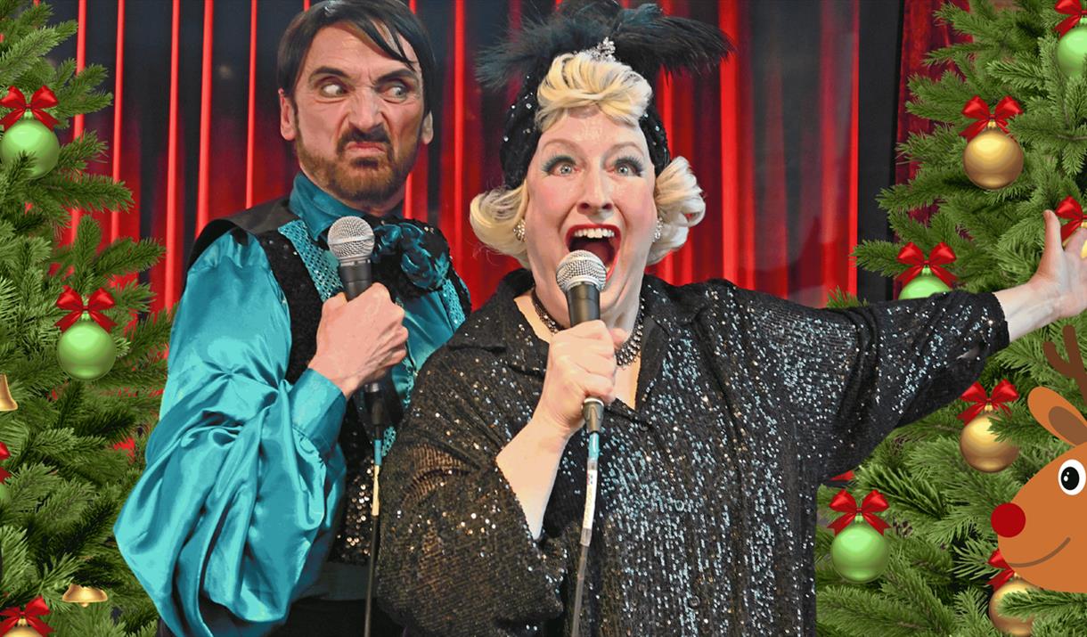 two people singing karaoke in Woolwich with Christmas trees in the background