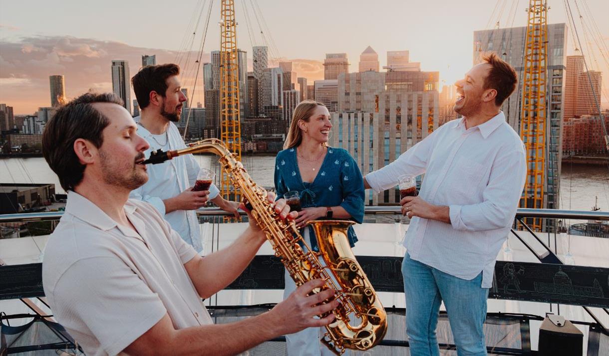 Exclusive Friday night climbs with a twist: refreshing beverage, sky-high sunsets, and live saxophonist performance playing classic summertime tunes