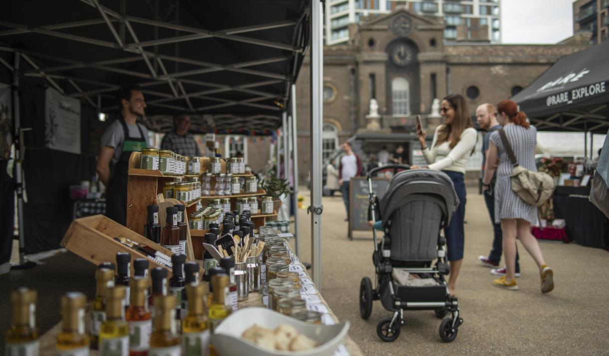 People stop to look at the range of goodies on offer at Royal Arsenal Farmers Market in Woolwich, Greenwich