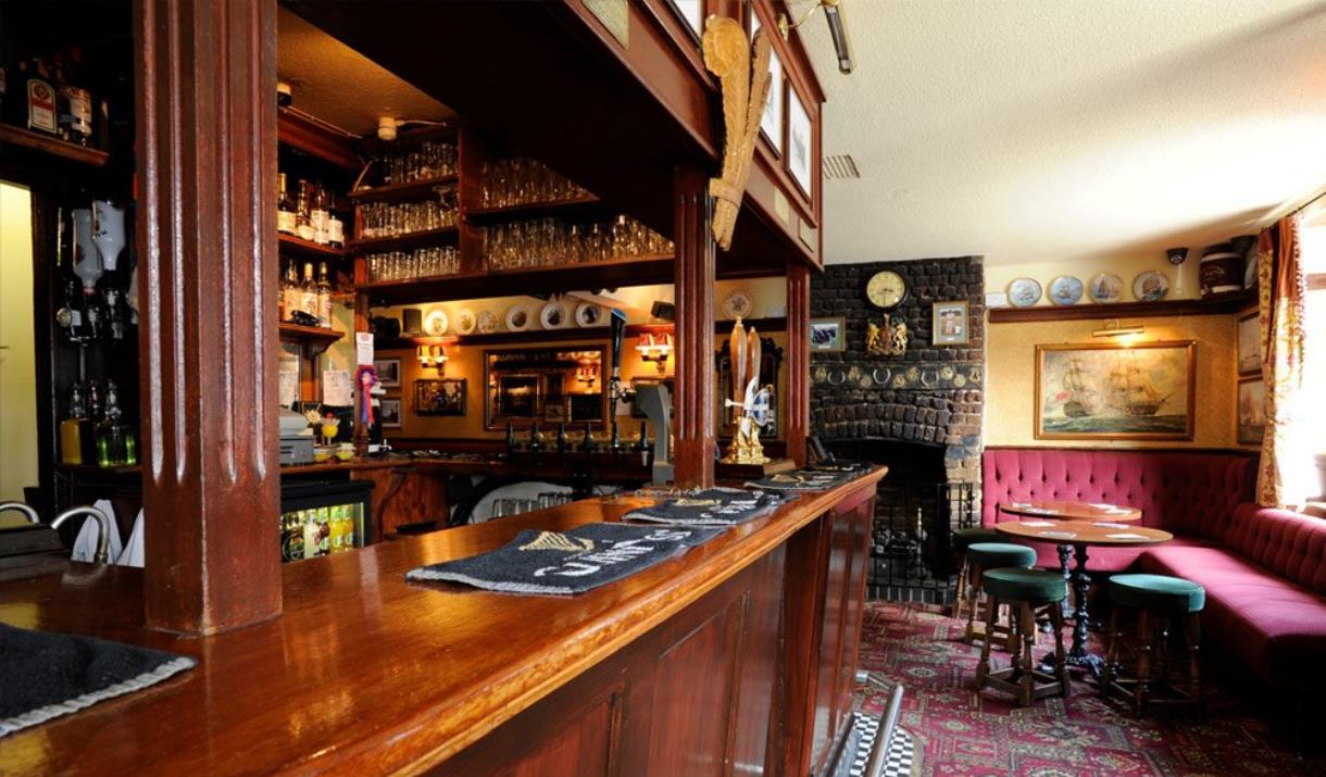 The beautiful old wooden bar at The Plume of Feathers in Greenwich.