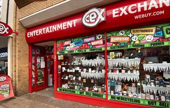 Outside CeX in Greenwich. A red shop front filled with electrical products.