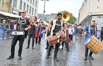 Brass band marching through Woolwich town centre