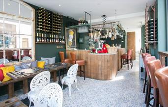 Interior image of Champagne + Fromage Greenwich restaurant with bar and dining area.