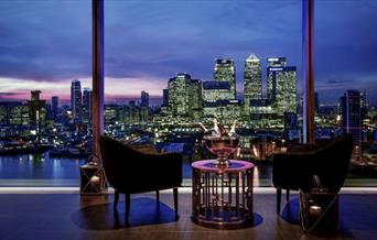 The romantic night-time view of Canary Wharf's glittering lights from Eighteen Sky Bar at InterContinental London - The O2.