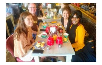 Family and friends enjoying having a nice meal while on the Greenwich Food Tour