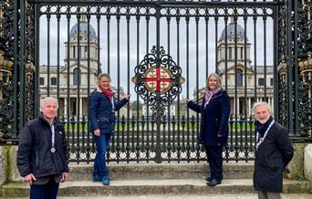 Image shows the Water Gate at The Old Royal Naval College and the two domes of Old Royal Naval College through the gates in the background.