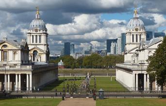 Beautiful Old Royal Naval College and its grounds with Canary Wharf skyline in the background.