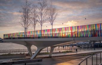 A colourful artwork wrapped on 700 m of walkway's glass balustrades, creating a ribbon of undulating colour.