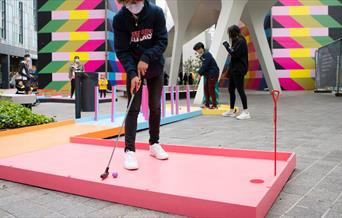 Swing into a summer of play with this family-friendly, fun-filled mini golf course designed by artist Yinka Ilori