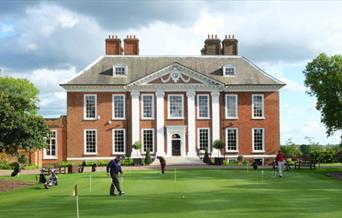 Image of Royal Blackheath Golf Club with golfers in action on the grounds.