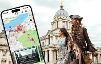 Film characters walk through the Old Royal Naval College. A mobile devide is overlaid showing the SetJetters App.