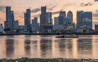 Speeding down the Thames past Canary Wharf on Uber Boat by Thames Clippers.