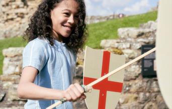 Child playing with sword and shield