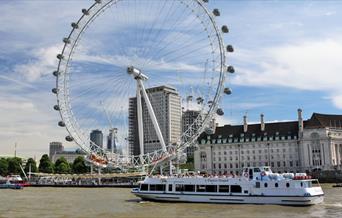 A Viscount Cruises boat sailing past the London Eye.