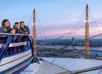 A family enjoy the view from Up at The O2 at sunset.