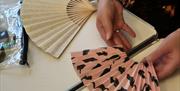 A live shot of facilitator Dawn Wylds mid Fan Making Workshop