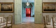 Open green doors looking through to rooms at the Admiral's House, Old Royal Naval College