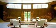 White chairs setup for a reception in the Entrance Hall of Eltham Palace and Gardens