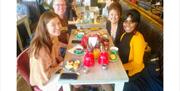 Family and friends enjoying having a nice meal while on the Greenwich Food Tour