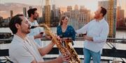 Exclusive Friday night climbs with a twist: refreshing beverage, sky-high sunsets, and live saxophonist performance playing classic summertime tunes