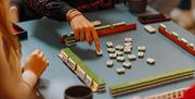 Learn the strategy and skill behind Mahjong - one of China’s most beloved traditional games