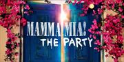 Mamma Mia! The Party entrance giving the feel of Greek island with blue wooden doors and pink flowers running across the wall