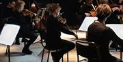 Dame Sarah Connolly and the Philharmonia Orchestra bring the largest orchestra performance ever to Cutty Sark with a selection of classical music mast