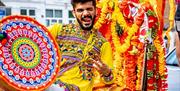 Enjoy the beats of dhol drummers filling the square with rhythm and celebration