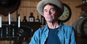 Montana’s transatlantic messenger returns with new rants, knife-edge observations, thrilling musical interludes and an ever-formidable knack for laugh