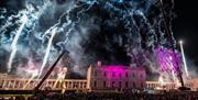 People stood in a crowd at night on the Royal Museums Greenwich Grounds
