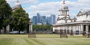 Green lawn at the Royal Museums Greenwich Grounds overlooking the Old Royal Naval College and Canary Wharf