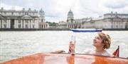 Thames Limo boat on the River Thames overlooking Old Royal Naval College