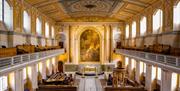 The beautiful neoclassical interior of the Chapel of St Peter and St Paul at the Old Royal Naval College in Greenwich