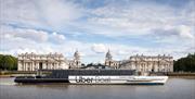 Uber Boat by Thames Clippers sailing on the River Thames overlooking the Old Royal Naval College