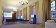 Chairs setup in theatre style in a meeting room in the University of Greenwich with drink station