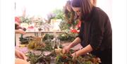 Make your very own wreath using fresh seasonal foliage, berries, dried fruits and flowers