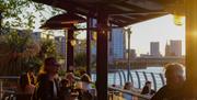 Sunset views of the London skyline from a buzzing riverside terrace at the Oystercatcher in Greenwich