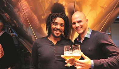 Two guys enjoy a sample of beer on a Meantime Brewery Tour in Greenwich.